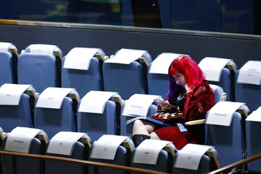 An attendee sits in the gallery during the 77th session of the United Nations General Assembly, at U.N. headquarters, Tuesday, Sept. 20, 2022. (AP Photo/Jason DeCrow)