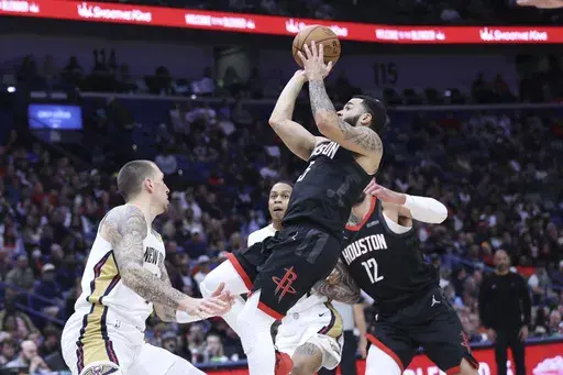 Houston Rockets guard Fred VanVleet (5) shoots a jumper in the paint against New Orleans Pelicans center Daniel Theis (10) in the first half of an NBA basketball game in New Orleans, Thursday, Dec. 26, 2024. (AP Photo/Peter Forest)
