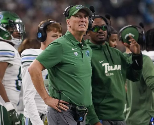 Tulane head coach Willie Fritz , center, looks on from the sideline during the second half of the Cotton Bowl NCAA college football game against Southern California, Jan. 2, 2023, in Arlington, Texas. At No. 24, Tulane enters this season as the only team from a mid-major conference in the AP Top 25. Fritz does not want to dismiss the hype entirely. It amounts to newfound respect for a team pegged to finish last in the AAC's 2022 preseason poll. (AP Photo/Sam Hodde, File)